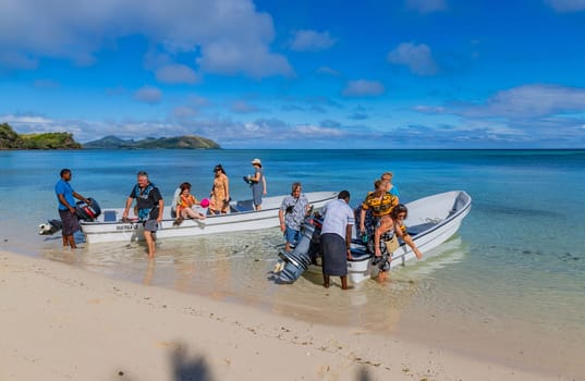 Nacula, Fiji: 26 May 2023: Tourists at the tropical sandy beach of Nacula island, Yasawa islands, Fiji, South Pacific Islands, Pacific