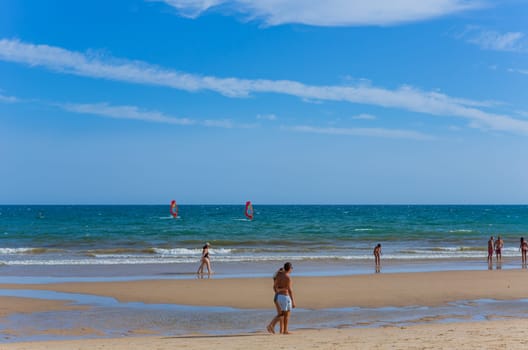 Tavira, Portugal - August 15, 2023: People at the famous beach of Tavira island in Tavira. This beach is a part of famous tourist region of Algarve.