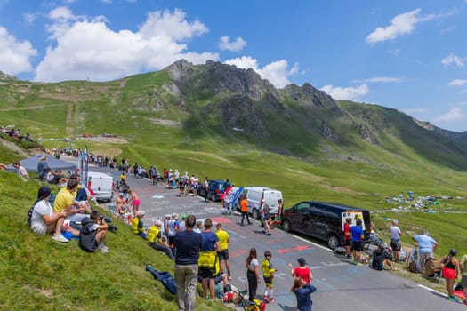 Col du Tourmalet, France - July 06 2023: Cycling fans waiting for the buch at the top of the Col du Tourmalet in Pyerenees mountains during the stage 6 of Le Tour de France 2023