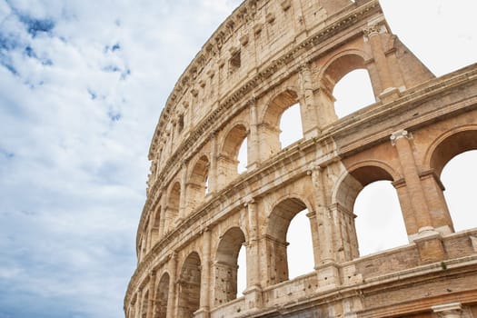 Background made of Colosseum with blue sky and clouds. Rome. Italy. Horizontally.