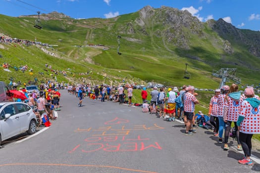 Col du Tourmalet, France - July 06 2023: Cycling fans waiting for the buch at the top of the Col du Tourmalet in Pyerenees mountains during the stage 6 of Le Tour de France 2023