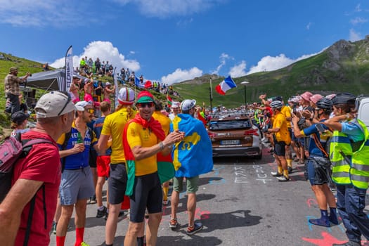 Col du Tourmalet, France - July 06 2023: Cycling fans waiting for the buch at the top of the Col du Tourmalet in Pyerenees mountains during the stage 6 of Le Tour de France 2023
