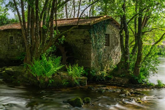 Long exposure near an ancient watermill in Cavado river, Braga, Portugal