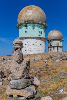Rocks in Torre and transmitting towers with golden cupola, the highest point of Portugal, in Serra da Estrela
