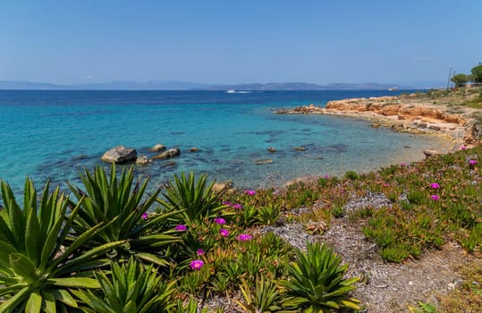 The coast of Aegina island with clear and blue waters of Mediterranean sea in the Saronic gulf, Greece.