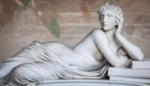 Pisa, Italy - 29 June 2023: sad statue in cemetery. Vintage white marble sculpture, woman sorrow