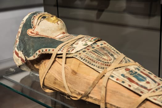 Turin, Italy - March 2023: Egyptian Museum, mummy of a baby with a mask - 2nd Century BC