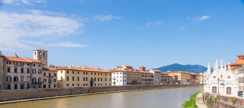 Pisa, Italy - 29 June 2023: colourful buildings on Arno river. Urban skyline, travel destination.