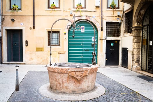 Verona, Italy - July 2022: the famous Well of Love, romantic sightseeing in the heart of the city