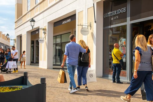 Agira, Sicily, Italy - 30 Sep 2023. Sicilia Outlet Village shopping centre is a popular visitor magnet. Passage with people where shopping at Outlet Village.