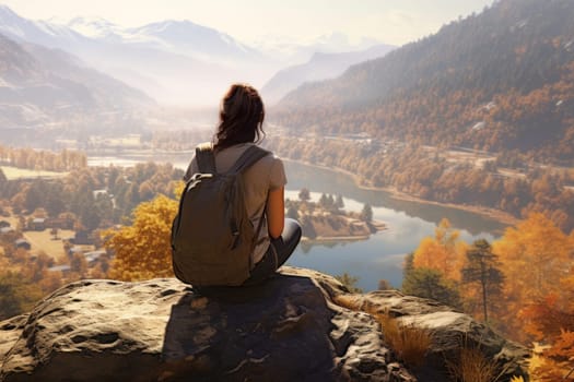 Mountain trip. Travel lifestyle. Exploring natural beauty. Woman sitting on rock and looking at mountain landscape. Hiking in mountains. Scenic view of mountain peaks, hills and valleys. Panoramic view. Natural scenery. Beauty in nature