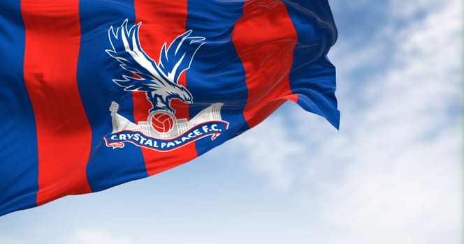 Selhurst, UK, October 2 2023: Crystal Palace football club flag waving in the wind on a clear day. Professional english Premier League team. Illustrative editorial 3d illustration render