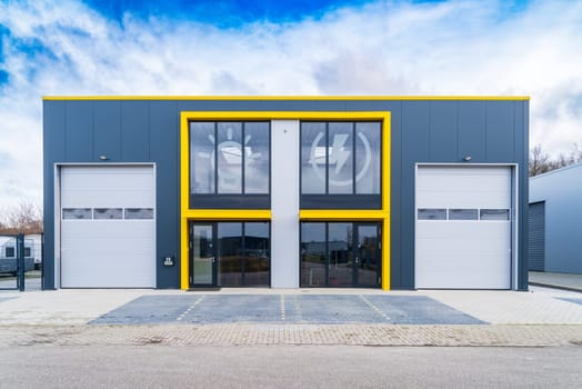 HENGELO, NETHERLANDS - JANUARY 30, 2021: Modern office building combined with a small warehouse unit