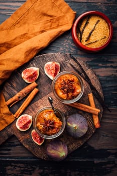 Homemade fig jam or jelly in a jar with cinnamon, vanilla and brown sugar
