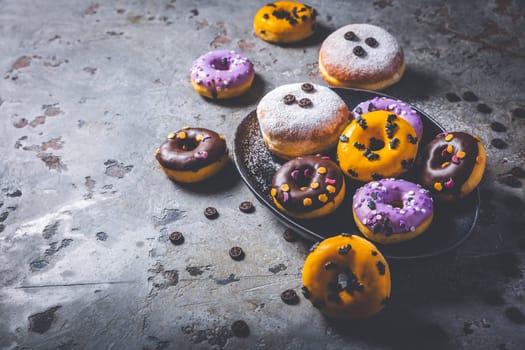Halloween donuts and Berliner with assorted frosting and sugar sprinkles for Halloween and carnival