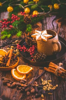 Christmas mulled red wine with spices and citrus fruits and gingerbread cookie