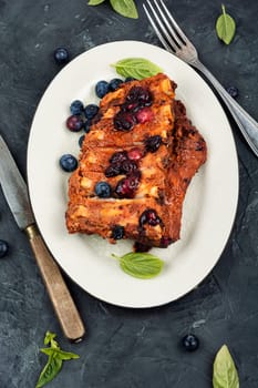 Fried pork ribs with blueberry sauce. Top view