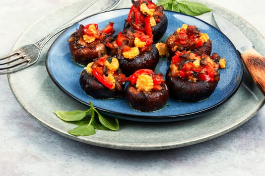 Mushroom, champignons caps baked stuffed with bell pepper and corn