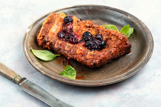 Fried pork ribs with blueberry sauce. Top view