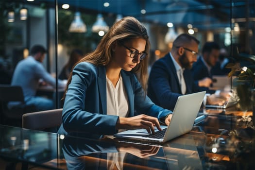 View of people working online with documents on a modern laptop in an open space workspace, business women and men