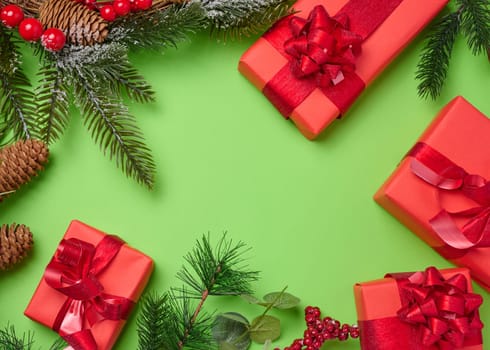 Christmas decor, gifts wrapped in red paper on a green background, top view