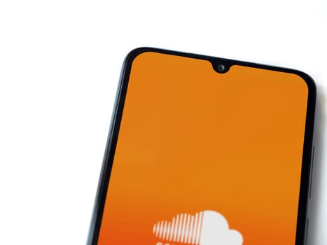 Lod, Israel - July 16,2023: SoundCloud app launch screen on smartphone on white background. Top view flat lay with copy space.