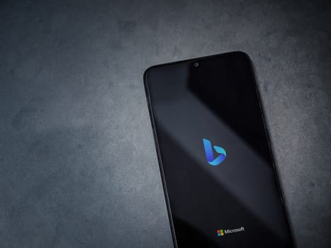 Lod, Israel - July 16,2023: Bing Browser app launch screen on smartphone on dark marble stone background. Top view flat lay with copy space.