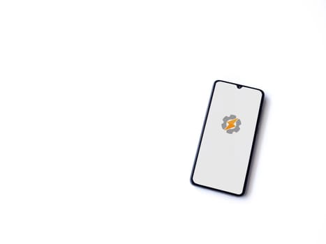 Lod, Israel - July 16,2023: Tasker app launch screen on smartphone on white background. Top view flat lay with copy space.