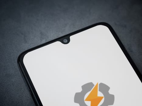 Lod, Israel - July 16,2023: Tasker app launch screen on smartphone on dark marble stone background. Top view flat lay with copy space.