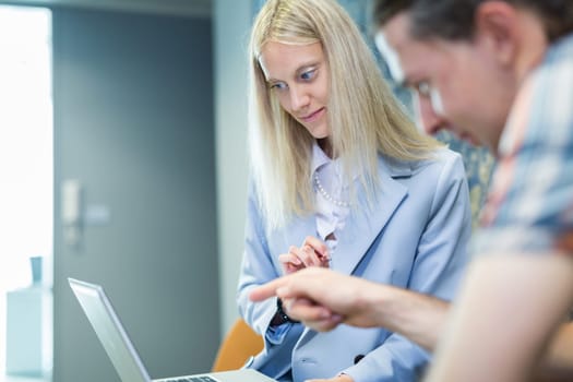 Business meeting. Client consulting. Confident business woman, real estate agent, financial advisor explaining details of project or financial product to client in office