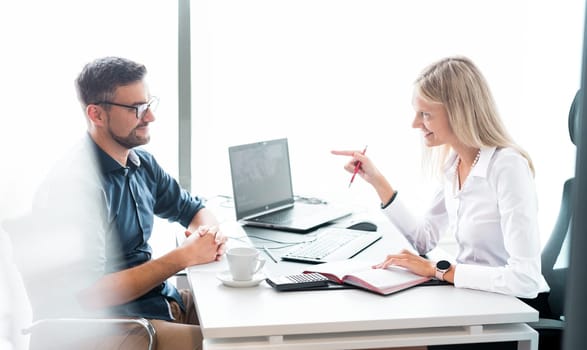 Business meeting. Client consulting. Confident business woman, real estate agent, financial advisor explaining details of project or financial product to client in office