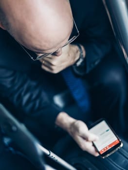 Businessman using his cell phones on subway. Business travel and communication concept. view from above. Vertical composition.