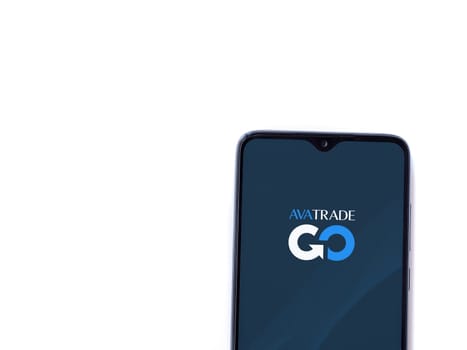 Lod, Israel - July 16,2023: Avatrade app launch screen on smartphone on white background. Top view flat lay with copy space.