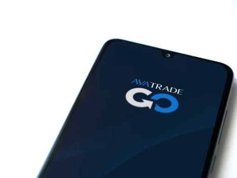 Lod, Israel - July 16,2023: Avatrade app launch screen on smartphone on white background. Top view flat lay with copy space.