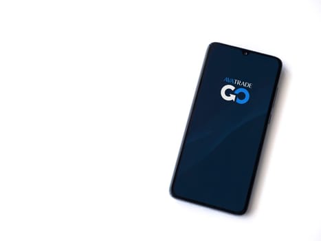 Lod, Israel - July 16,2023: Avatrade app launch screen on smartphone on white background. Top view flat lay with copy space.