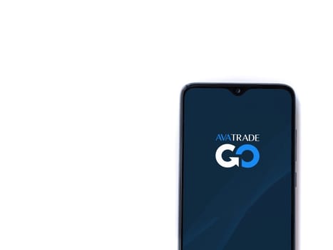 Lod, Israel - July 16,2023: Avatrade app launch screen on smartphone on white background. Top view flat lay with copy space.