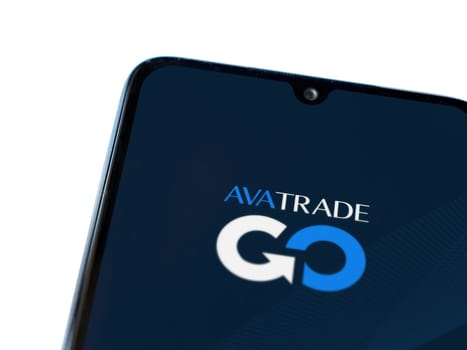Lod, Israel - July 16,2023: Avatrade app launch screen on smartphone on white background. Top view flat lay with copy space.