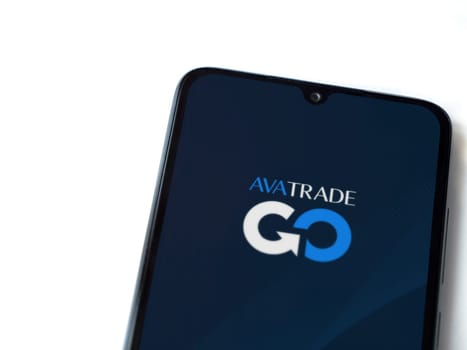 Lod, Israel - July 16,2023: Avatrade app launch screen on smartphone on white background. Top view flat lay with copy space.