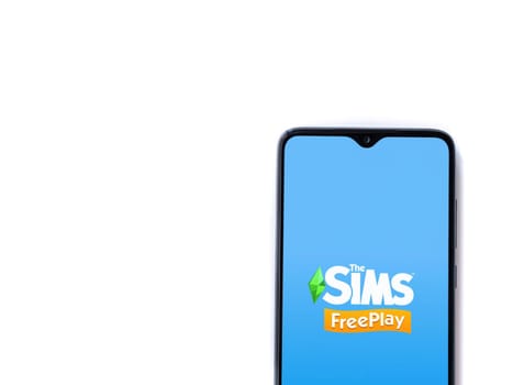 Lod, Israel - July 16,2023: The Sims FreePlay app launch screen on smartphone on white background. Top view flat lay with copy space.