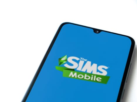 Lod, Israel - July 16,2023: The Sims Mobile app launch screen on smartphone on white background. Top view flat lay with copy space.