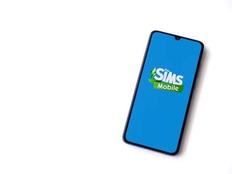 Lod, Israel - July 16,2023: The Sims Mobile app launch screen on smartphone on white background. Top view flat lay with copy space.