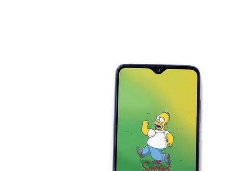 Lod, Israel - July 16,2023: The Simpsons Tapped Out app launch screen on smartphone on white background. Top view flat lay with copy space.