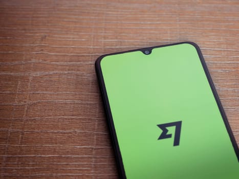 Lod, Israel - July 16,2023: Wise app launch screen on smartphone on wooden background. Top view flat lay with copy space.