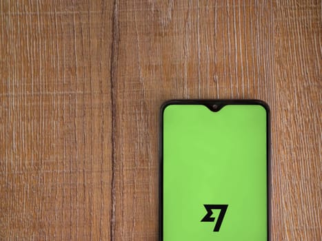 Lod, Israel - July 16,2023: Wise app launch screen on smartphone on wooden background. Top view flat lay with copy space.