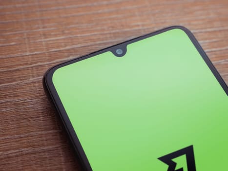 Lod, Israel - July 16,2023: Wise app launch screen on smartphone on wooden background. Top view flat lay with copy space.