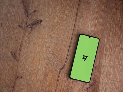 Lod, Israel - July 16,2023: Wise app launch screen on smartphone on wooden background. Top view flat lay with copy space.