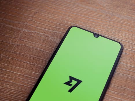 Lod, Israel - July 16,2023: Wise app launch screen on smartphone on wooden background. Top view flat lay with copy space.