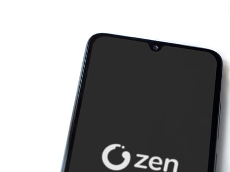 Lod, Israel - July 16,2023: ZEN.COM app launch screen on smartphone on white background. Top view flat lay with copy space.