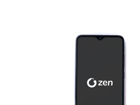 Lod, Israel - July 16,2023: ZEN.COM app launch screen on smartphone on white background. Top view flat lay with copy space.
