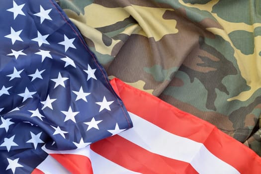 United States of America flag and folded military uniform jacket. Military symbols conceptual background banner for american patriotic holidays design